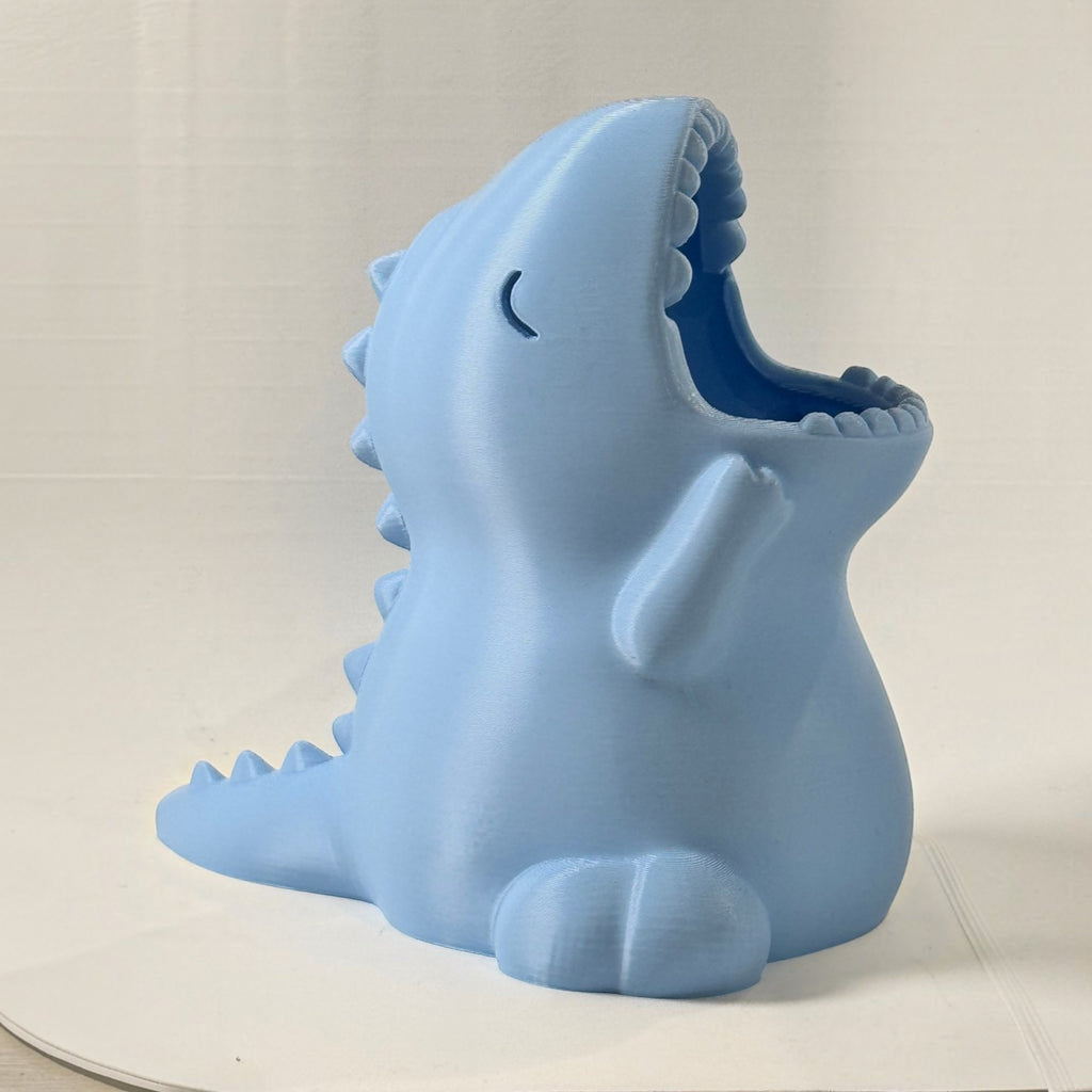 Porta-lápis Minha loja em formato de dinossauro azul claro para organização de mesa infantil